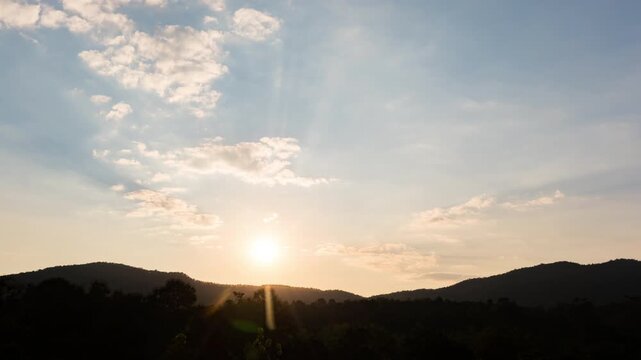 Time-lapse of a vibrant sunset over mountain peaks, changing sky colors from orange to twilight.