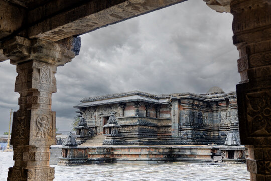 Belur Temple, a 900-year-old Hoysala masterpiece in Karnataka, India, featuring intricate stone carvings beneath dramatic monsoon clouds. Ideal for travel, heritage, architecture, history, and culture