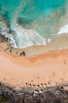 Aerial top view of the beach and turquoise waves, Fernando de Noronha, Pernambuco, Brazil