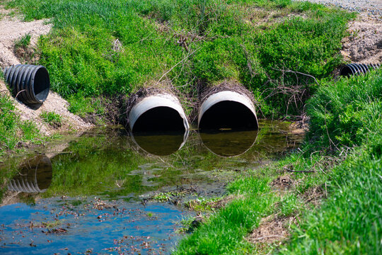 Drainage ditch moves water toward culvert. Drainage flow reduces erosion near creek. Sustainable systems rely on drainage control. Stormwater runoff needs drainage capacity.