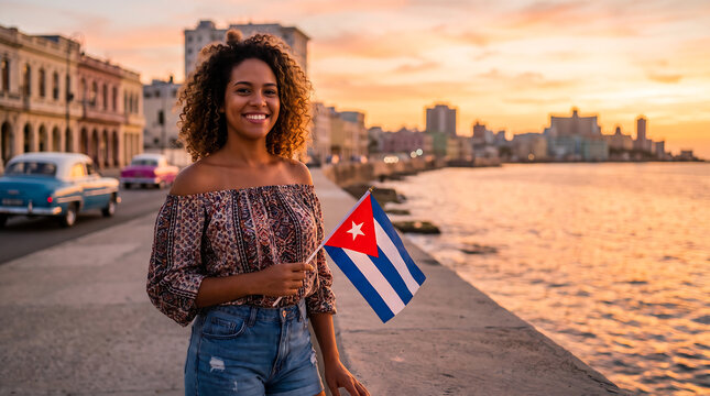 Woman holding Cuba flag at Havana Malecon during sunset