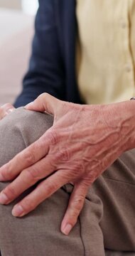 Hands, knee pain and senior person in home with leg injury, muscle tension or arthritis symptom. Retirement, old resident or joint sprain on sofa with osteoporosis complication or massage for relief
