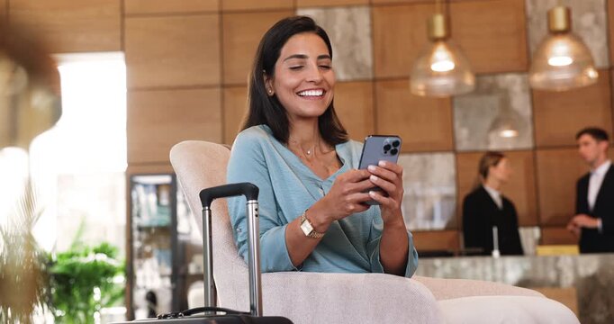 Young Brazilian woman holding smartphone seated comfortably in modern, upscale lobby of premium hotel, using convenient online booking services or managing business travel plans. Accommodations, tech
