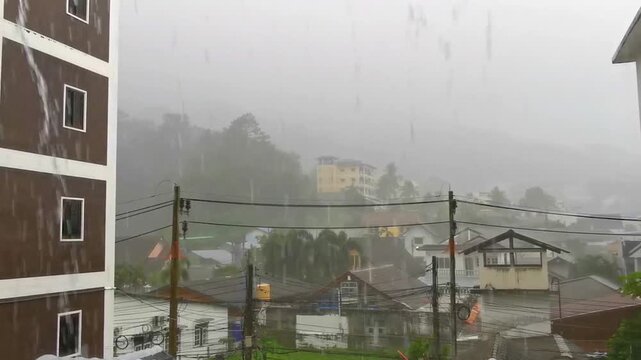 Extreme monsoon rain flooding tropical environment during dark evening night Thailand.