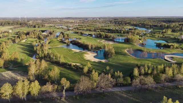 Aerial view of golf course with lakes and bunkers