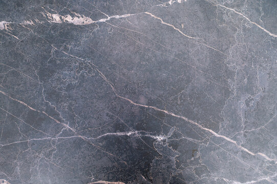 Gray marble texture with diagonal white veins across surface