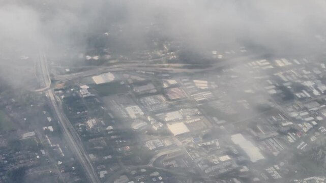 Aerial view of industrial park and highway through thick fog