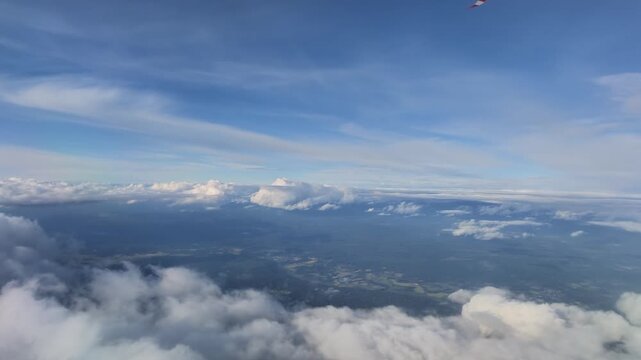 Aerial view of clouds and landscape from airplane window over Washington state