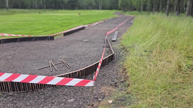 Walkway shows clear damage from ground shifting at park after heavy rain in summer season