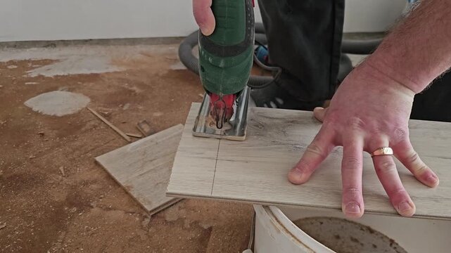 Cutting tiles with a power tool in a home setting during a renovation project