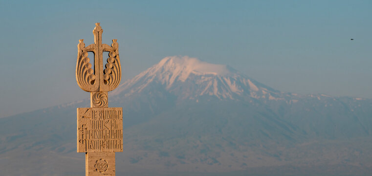 Revived Armenia monument stone detail with mount Ararat at sunset with copy space