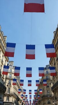 French flags hanging overhead on a city street, festive urban decoration for national holiday celebration, patriotic atmosphere in Europe