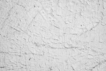 Fototapeta premium Rough white wall surface with visible texture and cracks