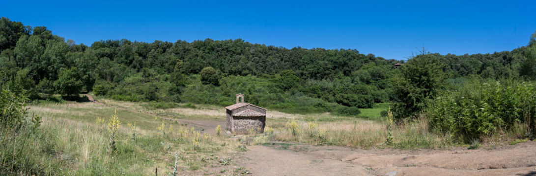 Santa Margarida volcano crater in La Garrotxa, Catalonia, Spain. Panoramic view of the small hermitage inside the extinct volcanic crater near Olot.