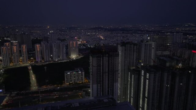 High rise buildings with ORR, vehicles and blue sky at Kokapet, Financial District, nanakramguda, hyderabad, telangana, india. night time, crane shot, drone shot, 4k.