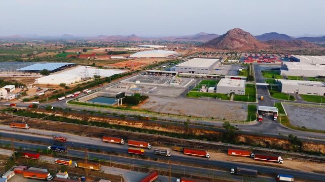 Aerial view of Hyundai Steel Private Limited with NH44, logistics vehicles and hills at Penukonda, Anantapur, andhra pradesh, india. day time, trucking shot, drone shot, 4k.