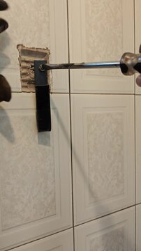 Installing black flat bar iron base using flathead screwdriver