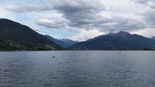 Zell am See, Austria - June 08 2026: Drone flying over the lake, following a boat, beautiful sunset and weather. Spring time in the alps.