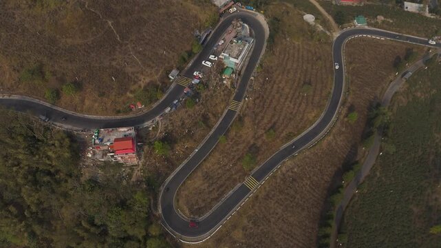 Drone view zigzag road in Mirik, North Bengal, India, at 4,905 feet. Stunning 4K aerial footage showcasing winding mountain roads, lush hills, and scenic Himalayan landscapes near Darjeeling.