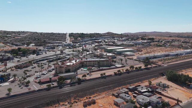 Rising aerial dolly shot along track tracks near Route 66 in Barstow, California. 4K
