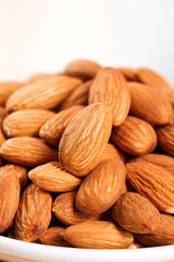 Fototapeta premium Fresh Roasted Almonds in White Bowl
