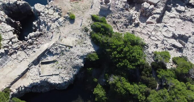 An aerial view of Lokrum Island, featuring the saltwater lagoon where tourists can float thanks to the high salinity on a sunny summer day and feel the tranquility; Lokrum, Dubrovnik, Croatia.