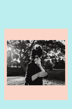 Silent Ninja. Graphic design poster portrait of a confident, happy curly haired young boy dressed up in a Ninja costume wearing a black mask handmade from mum's black panty hose stockings; Australia
