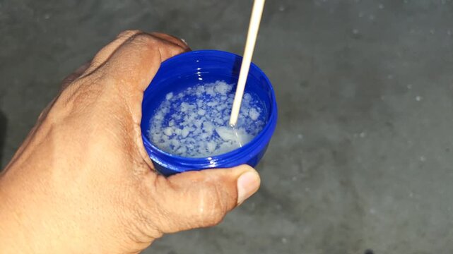 Preparing natural joint pain relief ointment mixing coconut oil and pine turpentine
