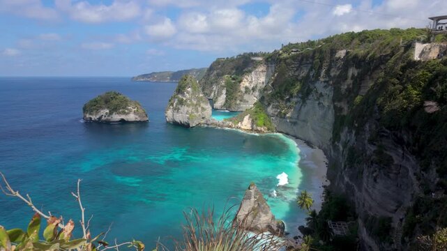 Diamond Beach /  Pantai Diamond in Nusa Penida, Bali . A slow motion push in shot of the white shores, dramatic cliffs and crystal-clear turquoise waters. 
