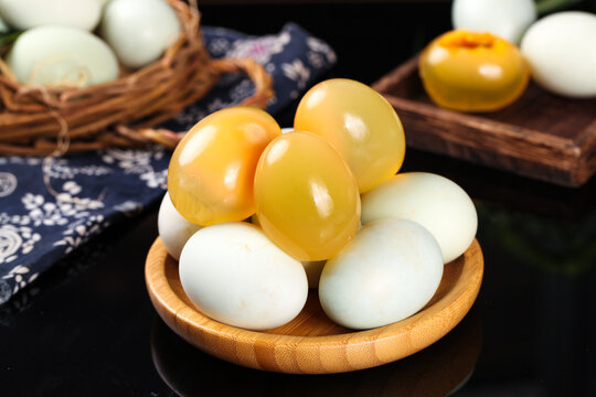 Chinese Preserved Eggs and Regular Eggs in Wooden Bowl - Traditional Asian Cuisine Ingredients