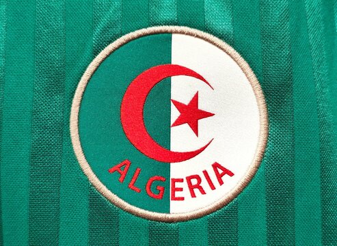Photo of the embroidered emblem of the Algeria national football team on the 2026 home kit. 