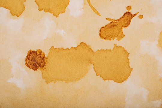 Close up texture of aged paper with coffee stains and liquid marks for background use
