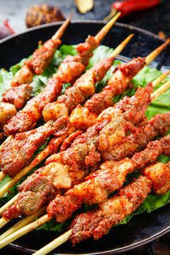 Spicy Grilled Meat Skewers on Lettuce Leaves - Asian Street Food Barbecue