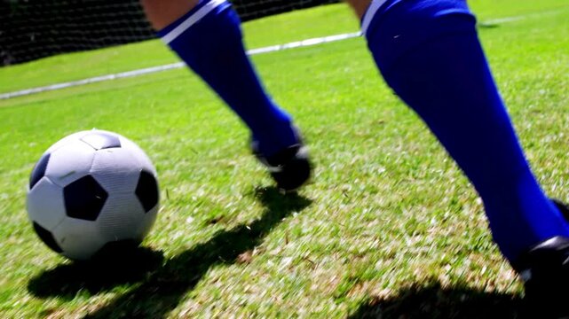 soccer player kicking the ball