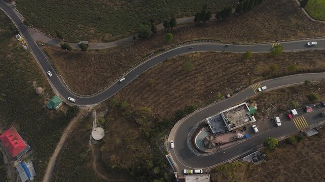 Drone view zigzag road in Mirik, North Bengal, India, at 4,905 feet. Stunning 4K aerial footage showcasing winding mountain roads, lush hills, and scenic Himalayan landscapes near Darjeeling.