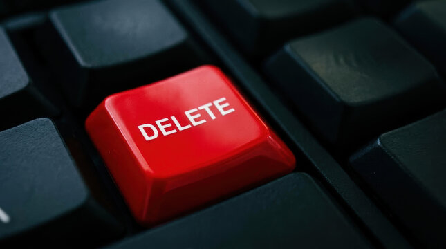 Delete key on black keyboard symbolizes cybersecurity threats and data protection in digital technology and computer security