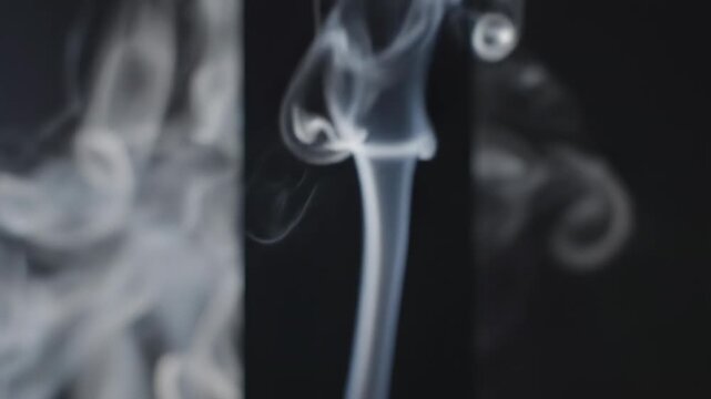 Smoke wisps gracefully rise and swirl against a dark background, creating an ethereal atmosphere with dynamic movement and fluid shapes captured in sequential frames