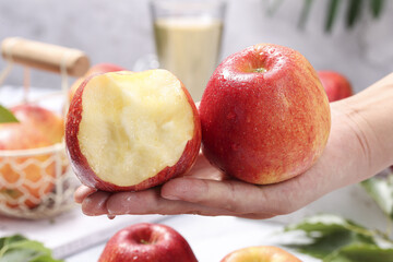 Fresh Red Apples in Hand - Whole and Half Cut Showing White Flesh for Healthy Eating © BuiThi