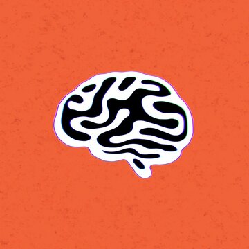 A black and white brain sticker sits on an orange surface, useful for education, psychology, learning, or mental health content.