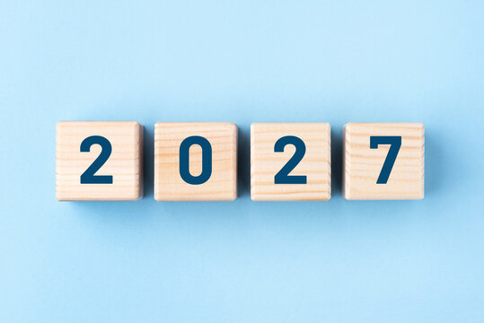 Wooden cubes with numbers of the New Year 2027 on a blue background
