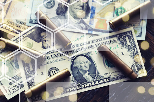 Live ammunition with bullets,  bills, close-up, selective focusing. Concept: sale of weapons under lend-lease, assistance with weapons, mercenaries in the army, trade in ammunition.