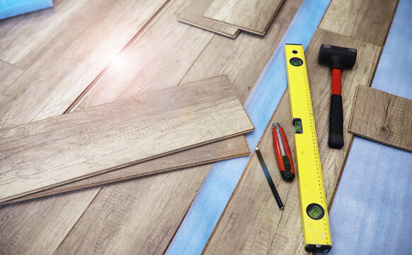 Longitudinal lock joint - The sequence of technological methods for laying and installation of floating flooring - laminate - professional work  - selective focus