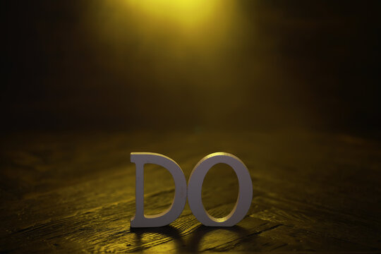 Motivational Word 'Do' Against Dramatic Yellow Light Background: Inspiration and Action Concept