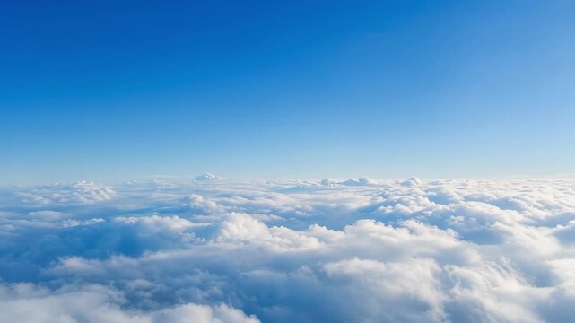 View of fluffy white clouds beneath a clear blue sky