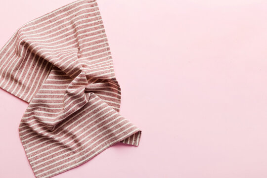 top view with red empty kitchen napkin isolated on table background. Folded cloth for mockup with copy space, Flat lay. Minimal style