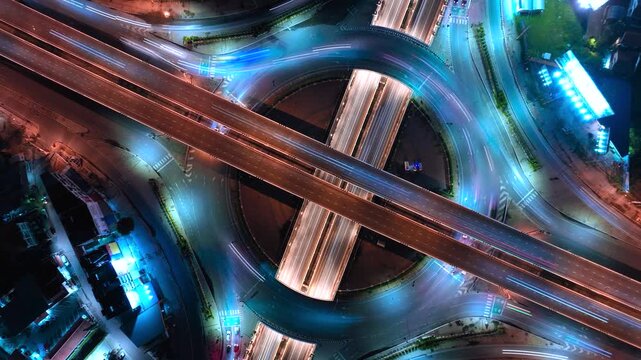 Expressway top view, Road traffic an important infrastructure, car traffic transportation above intersection road in city night, aerial view cityscape of advanced innovation, financial technology