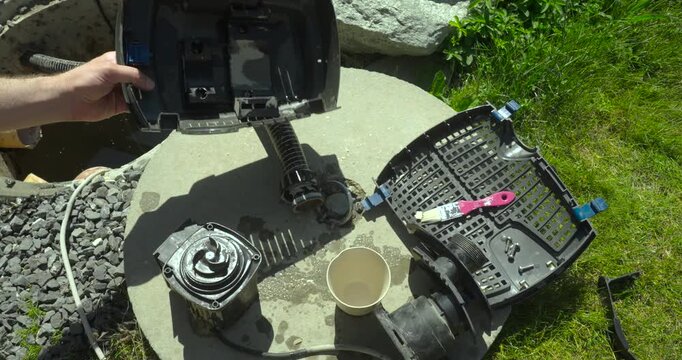 Close-up of a disassembled water pump with components covered in heavy limescale during maintenance. Concept of pump repair, descaling, inspection, and mechanical servicing.