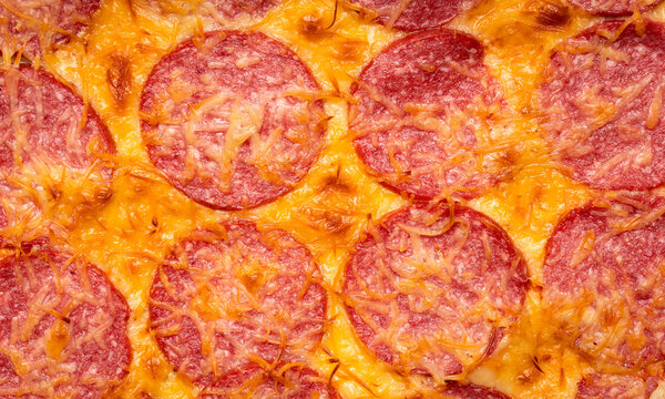 Homemade rustic pizza with sausage and cheese. Shot from above.