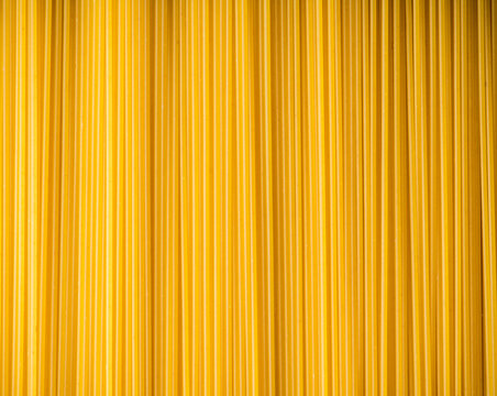 Dry spaghetti as textured background. Shot from above. Background and textures.