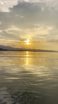 Slow Motion of Golden Sunset Over Calm Water